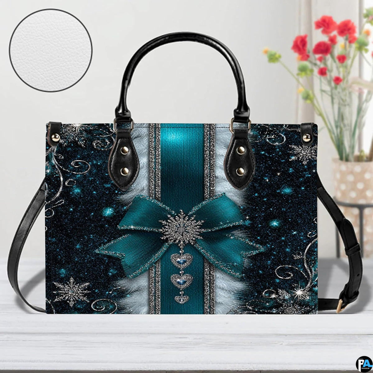 Display view of teal snowflake handbag on a white surface with circular texture detail swatch.