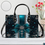 Display view of teal snowflake handbag on a white surface with circular texture detail swatch.