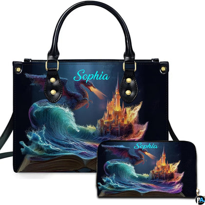 Storybook ocean wave and dragon castle artwork displayed across top-handle handbag and matching zip wallet.