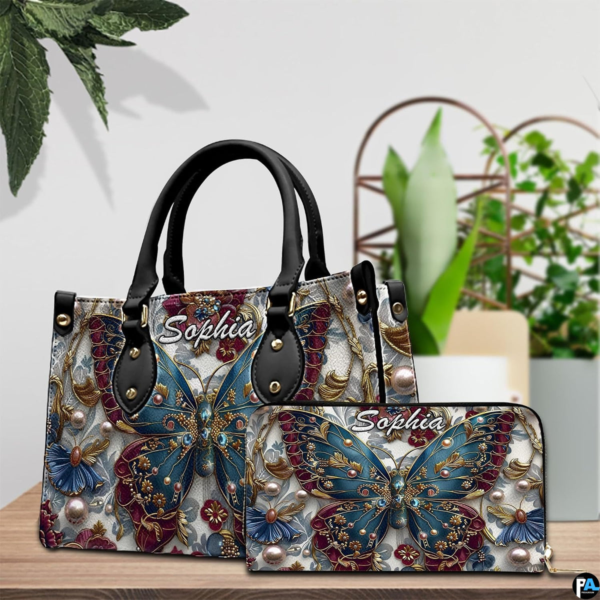 Close-up front view of handbag showing teal butterfly and gold filigree