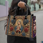 Matching Virgin Mary handbag and wallet set styled in indoor botanical setting