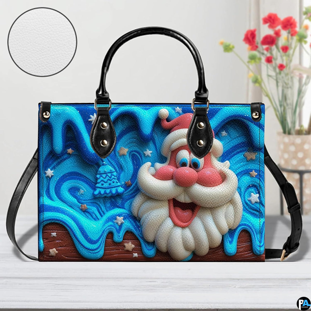 Tabletop lifestyle presentation of blue drip glaze Santa holiday handbag next to floral vase