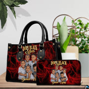 Alternative view displaying crimson handbag with dark trim and vivid red lightning art.