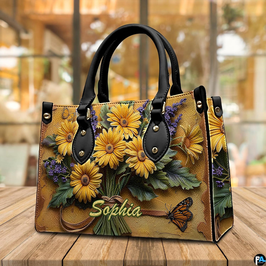 Alternative angle display of yellow daisy bouquet handbag and wallet
