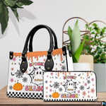 Pair showcase featuring cartoon ghost artwork placed on wooden tabletop beside leafy potted plant.