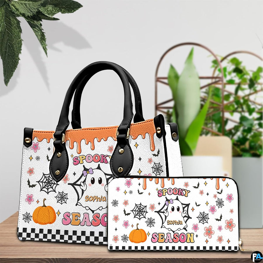 Pair showcase featuring cartoon ghost artwork placed on wooden tabletop beside leafy potted plant.