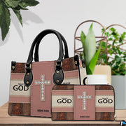 Detailed perspective of faith crystal cross handbag highlighting handle mounts and cross motif.