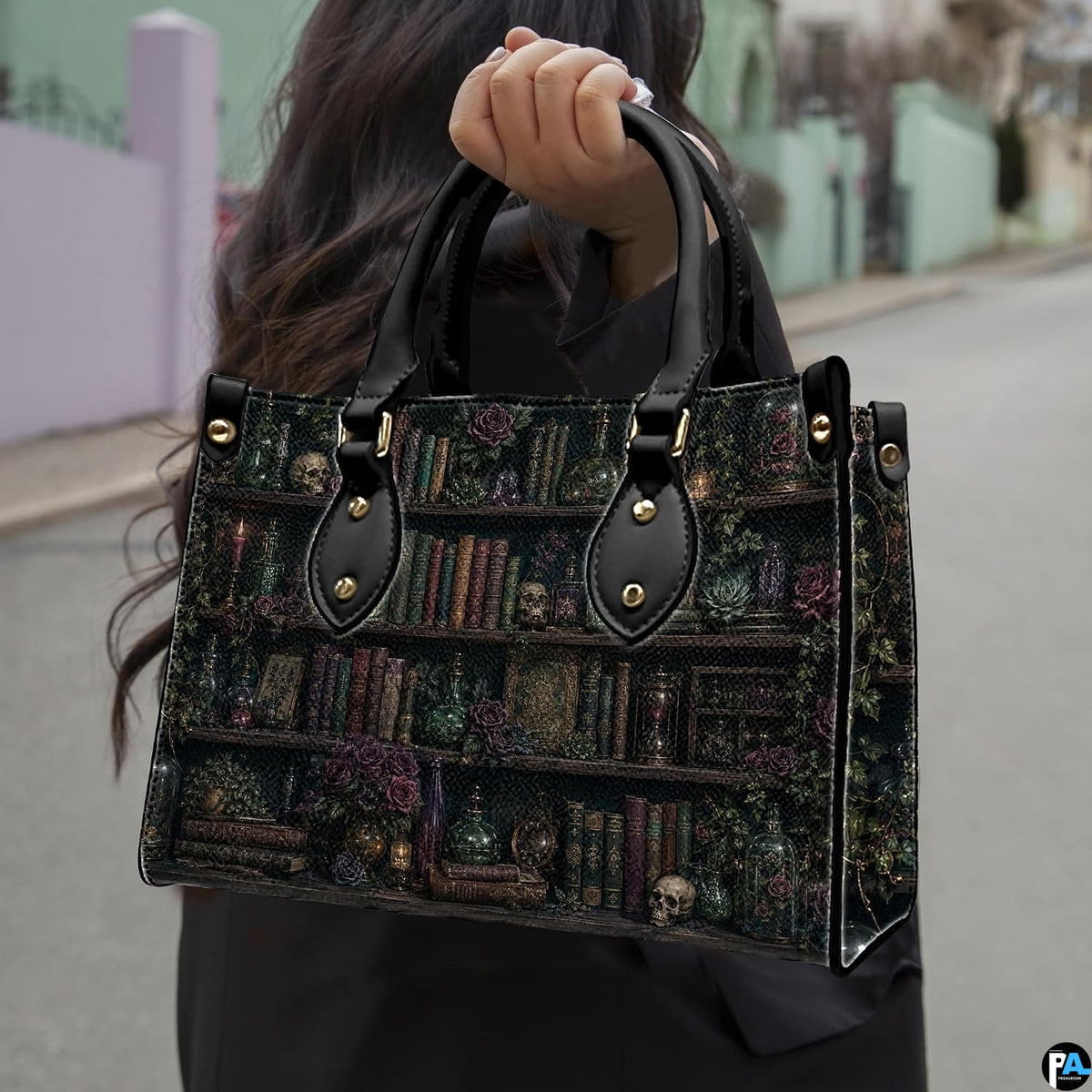 Angled view displaying the dark academia library shelf print across the structured handbag.