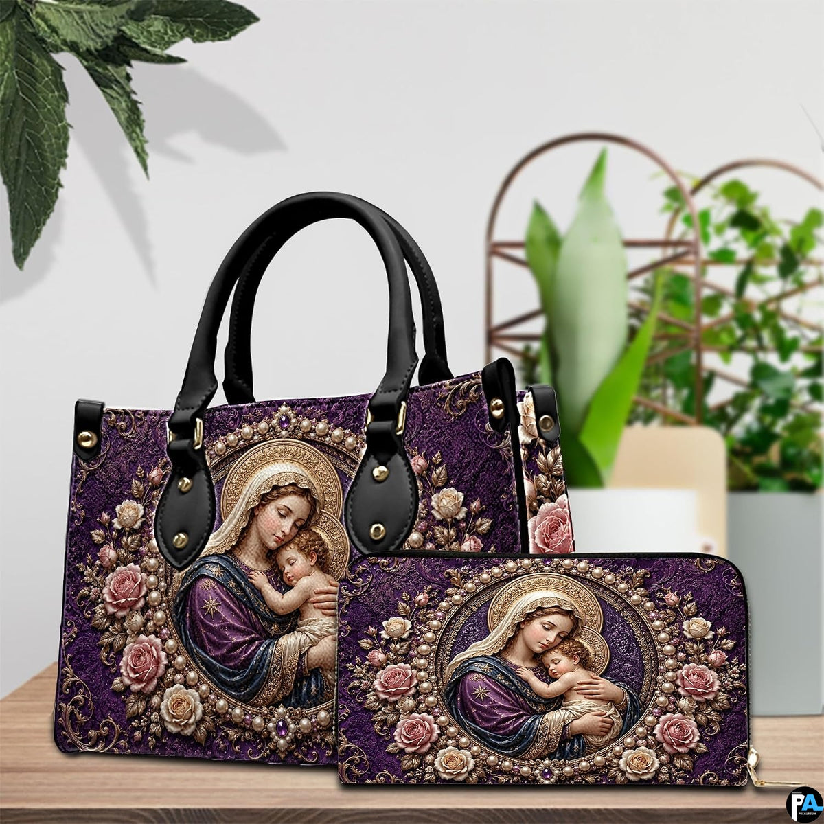 Handbag and matching wallet set featuring purple Madonna and Child art on wooden table