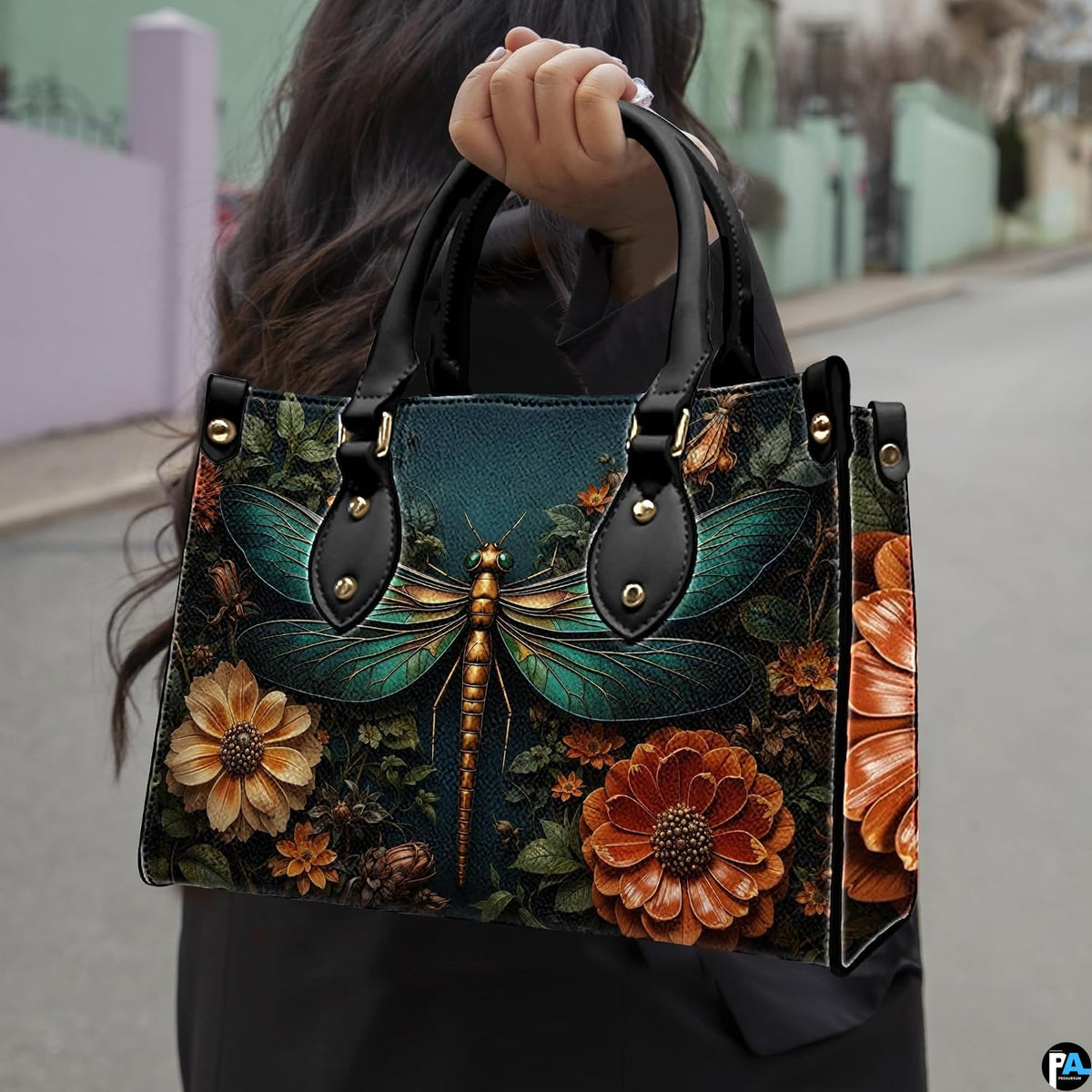 Front view of dragonfly handbag featuring emerald wings and blooming amber dahlias on dark slate teal