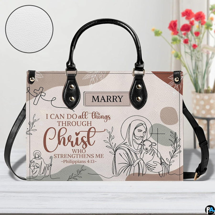 Jesus line art handbag on white table beside floral bouquet with texture swatch inset.