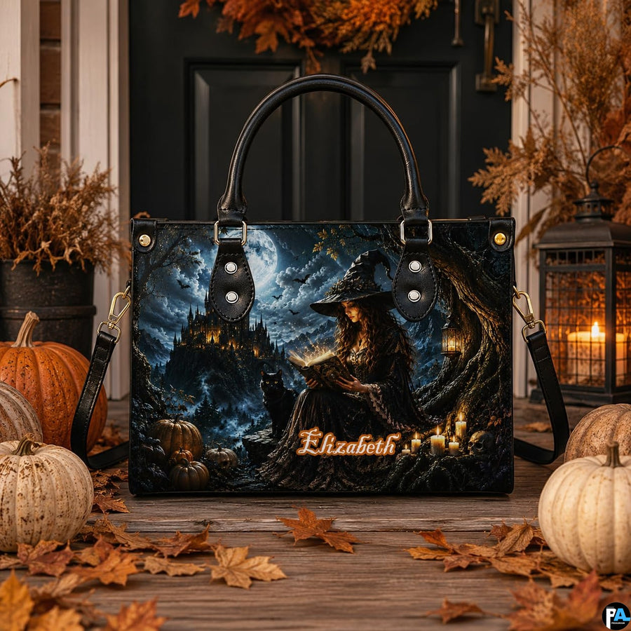 Halloween witch satchel placed on porch wooden floor surrounded by white pumpkins, autumn leaves, and lantern.