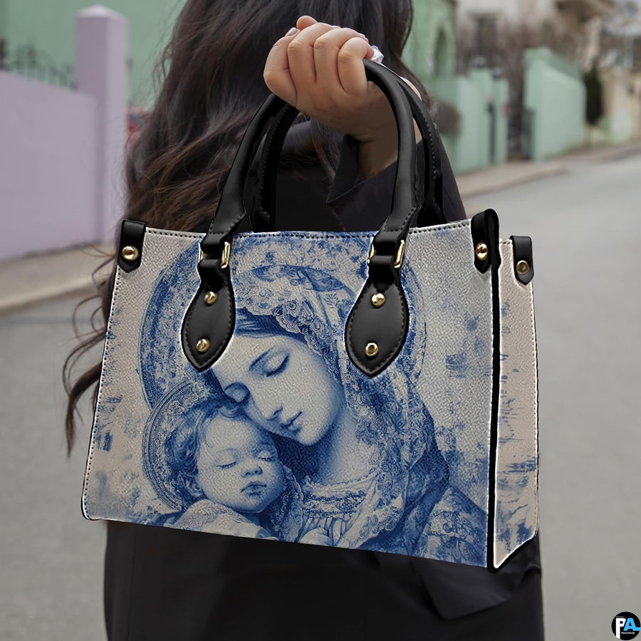 Lifestyle model carrying the blue Madonna and Child devotional handbag on street
