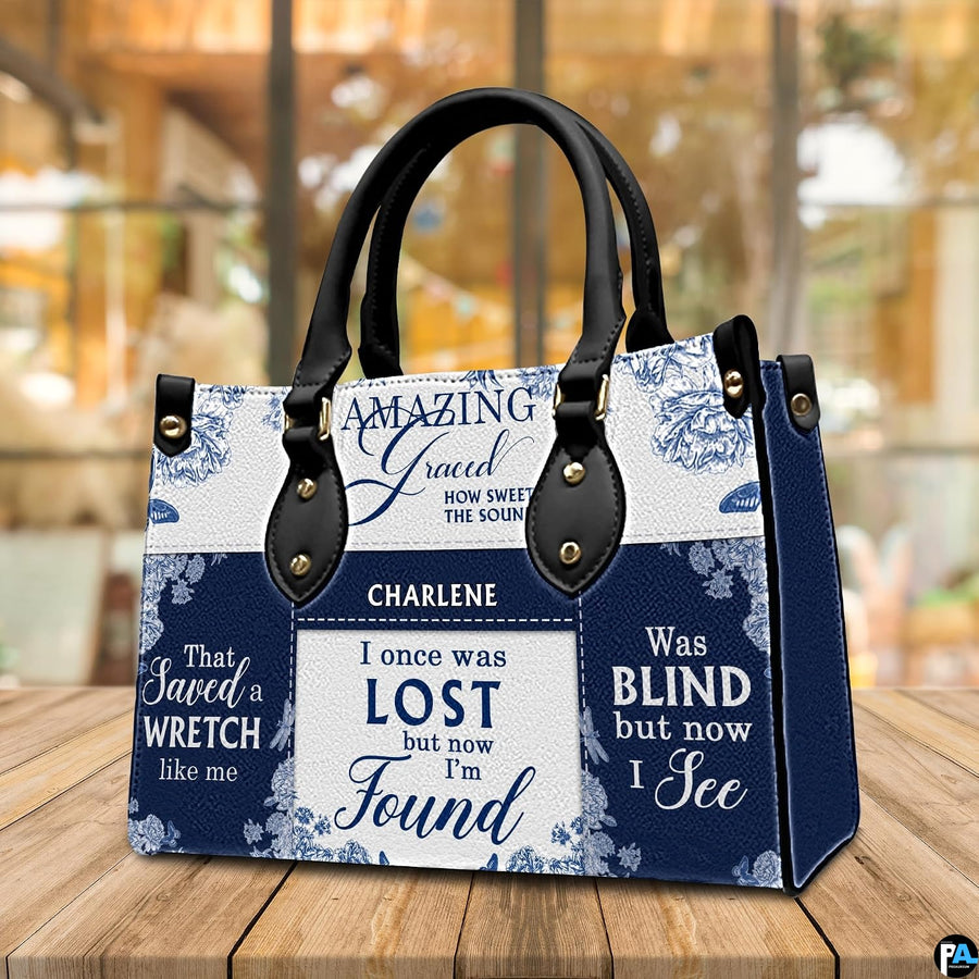 Rear view of structured navy and porcelain floral patterned handbag