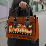 Outdoor perspective showing model holding brown corgi pup motif accessory by top handle.