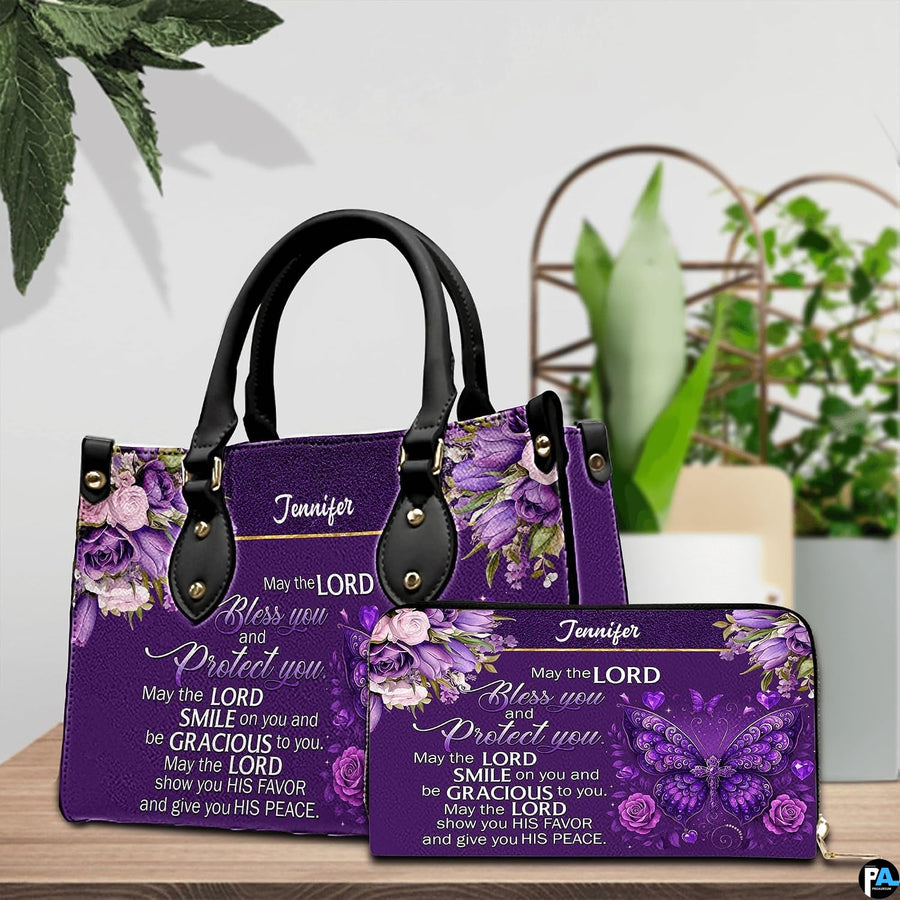 Christian blessing violet handbag and matching wallet set on wooden table near houseplant.