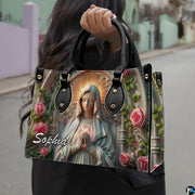 Stone relief Virgin Mary illustration framed by cathedral arch on handbag silhouette