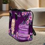 Perspective view of the Purple Floral Clinician Handbag standing on a light carpeted surface.