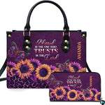 Front view of purple sunflower leopard handbag and matching zip wallet on solid white background