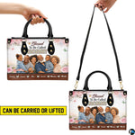 Perspective angle view of floral handbag highlighting side depth and continuous rose border pattern.