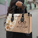 Model carrying structured sculpted lily and scripture handbag outdoors