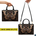 Carrying options demonstration illustrating handheld and shoulder wear for the bronze butterfly handbag.