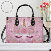 Angle perspective view of the unicorn handbag highlighting the sparkling pink print.