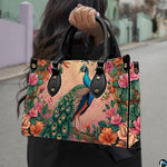 Woman carrying a pink floral peacock handbag by the top handles