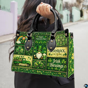 Model carrying green clover collage handbag with folklore motifs
