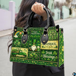 Model carrying green clover collage handbag with folklore motifs