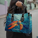 Front angled view showing the bright orange mosaic turtle gliding across cyan wave ribbons.