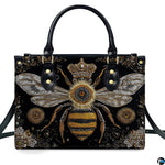Back view of bee handbag displaying continuous black background with golden scroll motifs.