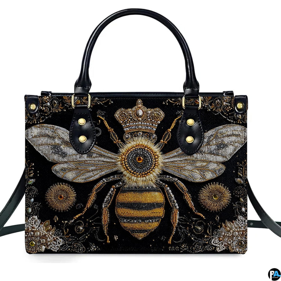 Back view of bee handbag displaying continuous black background with golden scroll motifs.