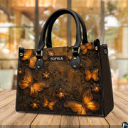 Butterfly handbag standing upright on a wooden terrace table with a bright cafe interior visible behind.