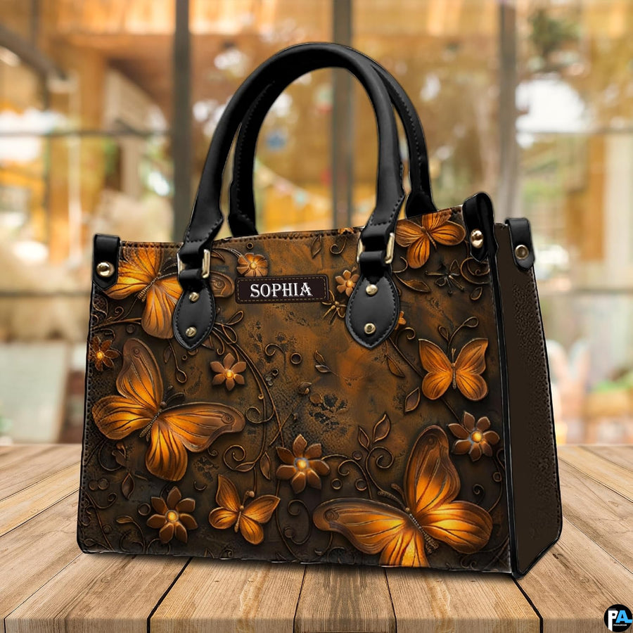 Butterfly handbag standing upright on a wooden terrace table with a bright cafe interior visible behind.