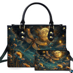 Studio display of celestial moonlit dragonfly handbag and matching wallet with glowing daisies and full moon