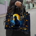 Outdoor view showcasing gothic black cat artwork held alongside an urban walkway.