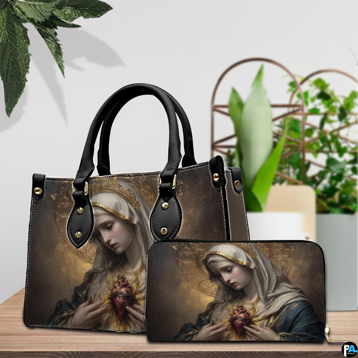 Immaculate Heart of Mary handbag and wallet set arranged on wooden table with green plants