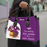 Product diagram highlighting handle buckles, removable shoulder strap, zipper pull, and lining.
