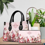 Handbag and matching zip wallet set displayed on wooden tabletop surrounded by green plants.