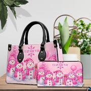 Handbag and matching zip-around wallet displayed on a wooden tabletop showing coordinated snowman artwork.