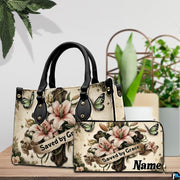 Detailed view of lily cross handbag showing handle hardware and delicate lily petals.