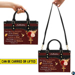 Top angle view showing black carrying handles and main zippered opening of burgundy floral purse.