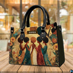 Sisterhood African American artwork resting upright on a wooden cafe tabletop.