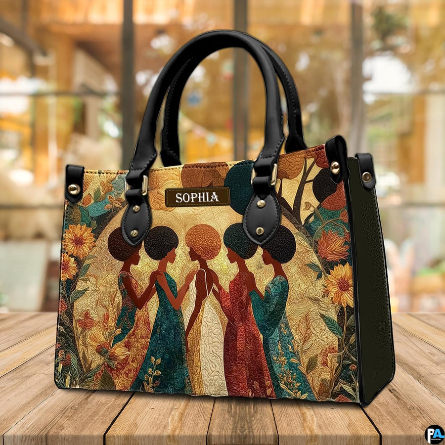 Sisterhood African American artwork resting upright on a wooden cafe tabletop.