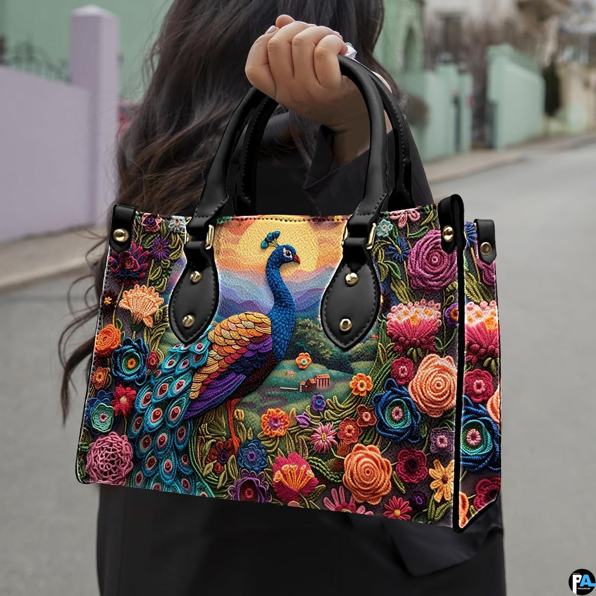 Woman carrying a peacock floral handbag with golden sun and mountain scene
