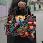 Woman carrying a peacock floral handbag with golden sun and mountain scene