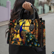 Woman carrying a stained-glass-style peacock handbag