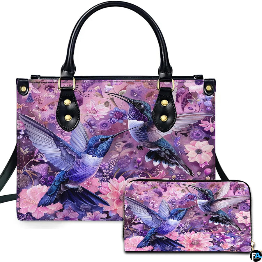 Front view of purple dual hummingbird handbag and matching wallet with blooming pink and violet flowers.