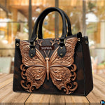 Baroque filigree butterfly handbag resting on an outdoor cafe table beside a beverage.